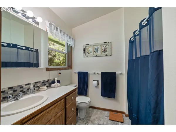 a bathroom with a sink toilet and mirror