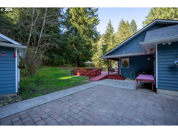 a view of a house with a yard and sitting area