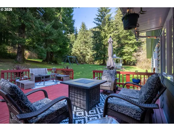 a view of a patio with table and chairs potted plants and a palm tree