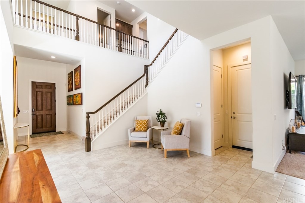 19047 Bension Drive Saugus, CA 91350 - Photo 11 of 72 Extended entry with view of upstairs balcony, garage access and storage closet under the staircase.