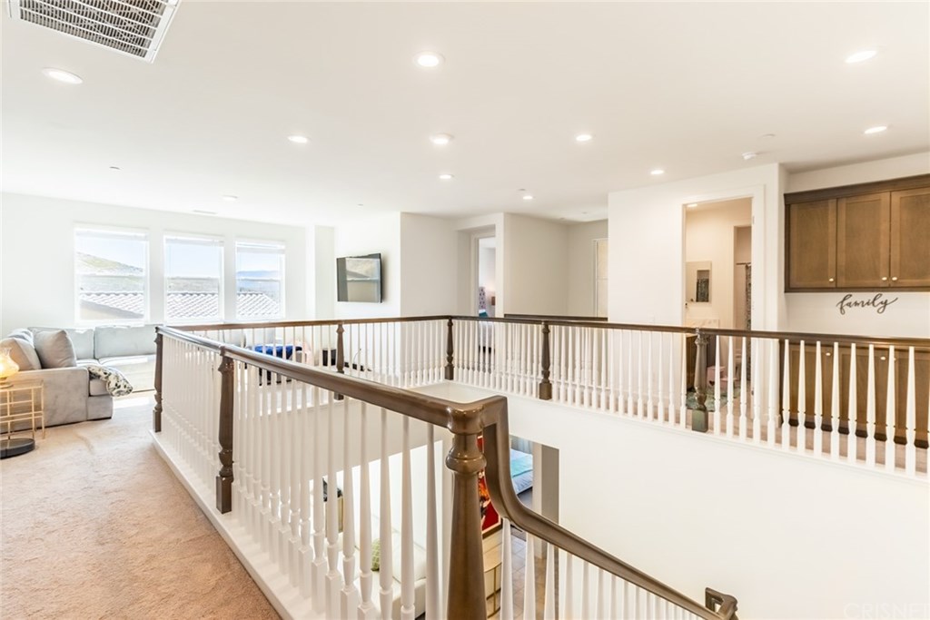 19047 Bension Drive Saugus, CA 91350 - Photo 24 of 72 Top of the staircase with view of loft space, bedroom four, bathroom, and upgraded cabinetry.