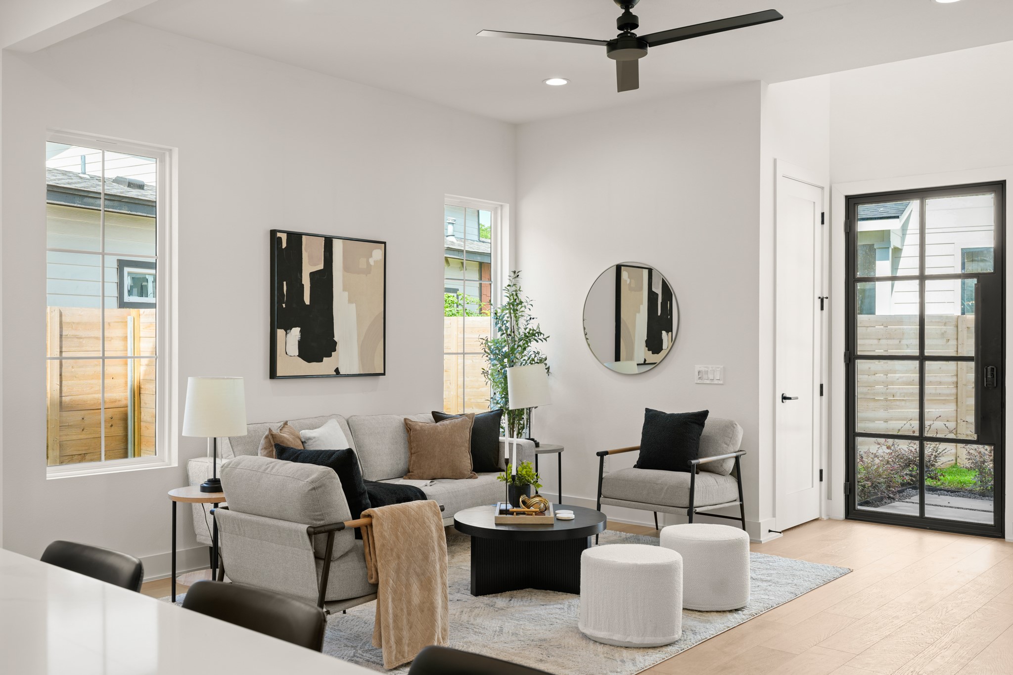 601 Vermont Road, Unit 2 Austin, TX 78702 - Photo 4 of 31 A contemporary living area bathed in natural light features light hardwood flooring and recessed ceiling lights, offering a serene atmosphere.