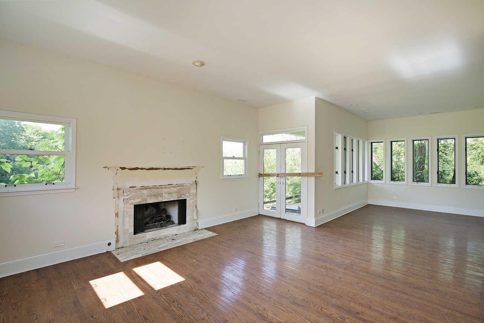 3000 Telegraph Road Bannockburn, IL 60015 - Photo 13 of 18 an empty room with wooden floor fireplace and windows