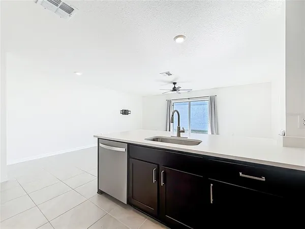 a kitchen with granite countertop a refrigerator and a sink