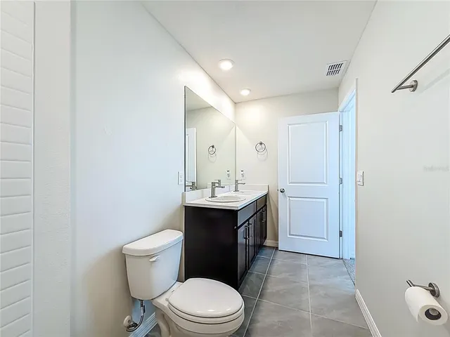 a view of a room with a ceiling fan and a window
