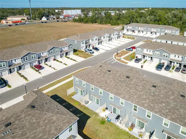 an aerial view of residential houses with outdoor space