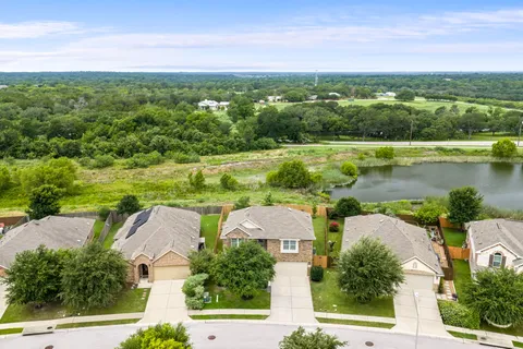an aerial view of residential houses with outdoor space and city view