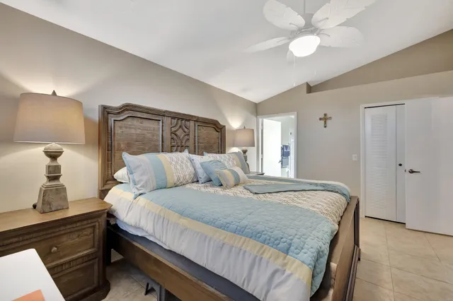 a bedroom with a bed and a lamp