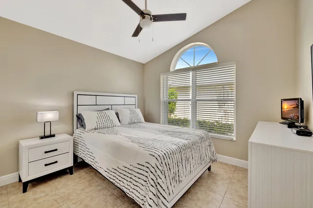 a bedroom with furniture and a flat screen tv
