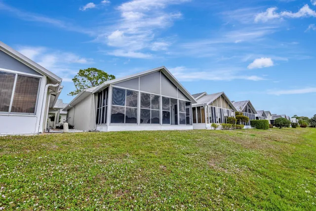 a view of a house with a yard and sitting area