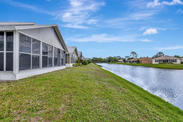 a view of a lake with houses in the back