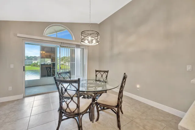 a view of a dining room with furniture and a chandelier