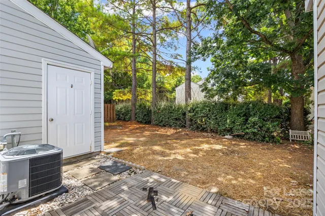 a backyard of a house with glass door and glass windows