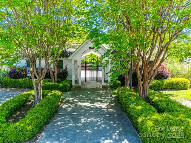 an aerial view of a house with a garden and a swimming pool