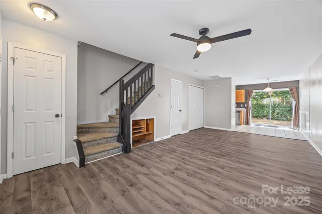 a view of empty room with wooden floor and window
