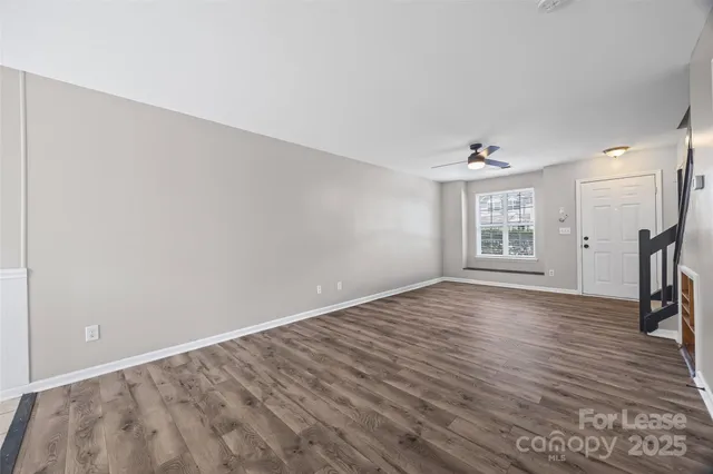 a view of an entryway with wooden floor and windows