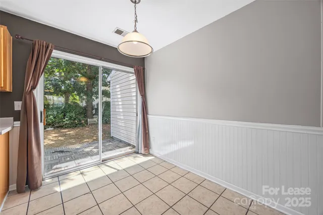 a kitchen with stainless steel appliances granite countertop a refrigerator a stove and a sink