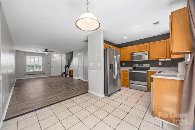 a kitchen with stainless steel appliances a stove sink and microwave