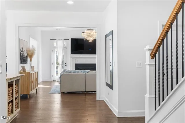 a kitchen with stainless steel appliances granite countertop a sink a stove and a wooden floor