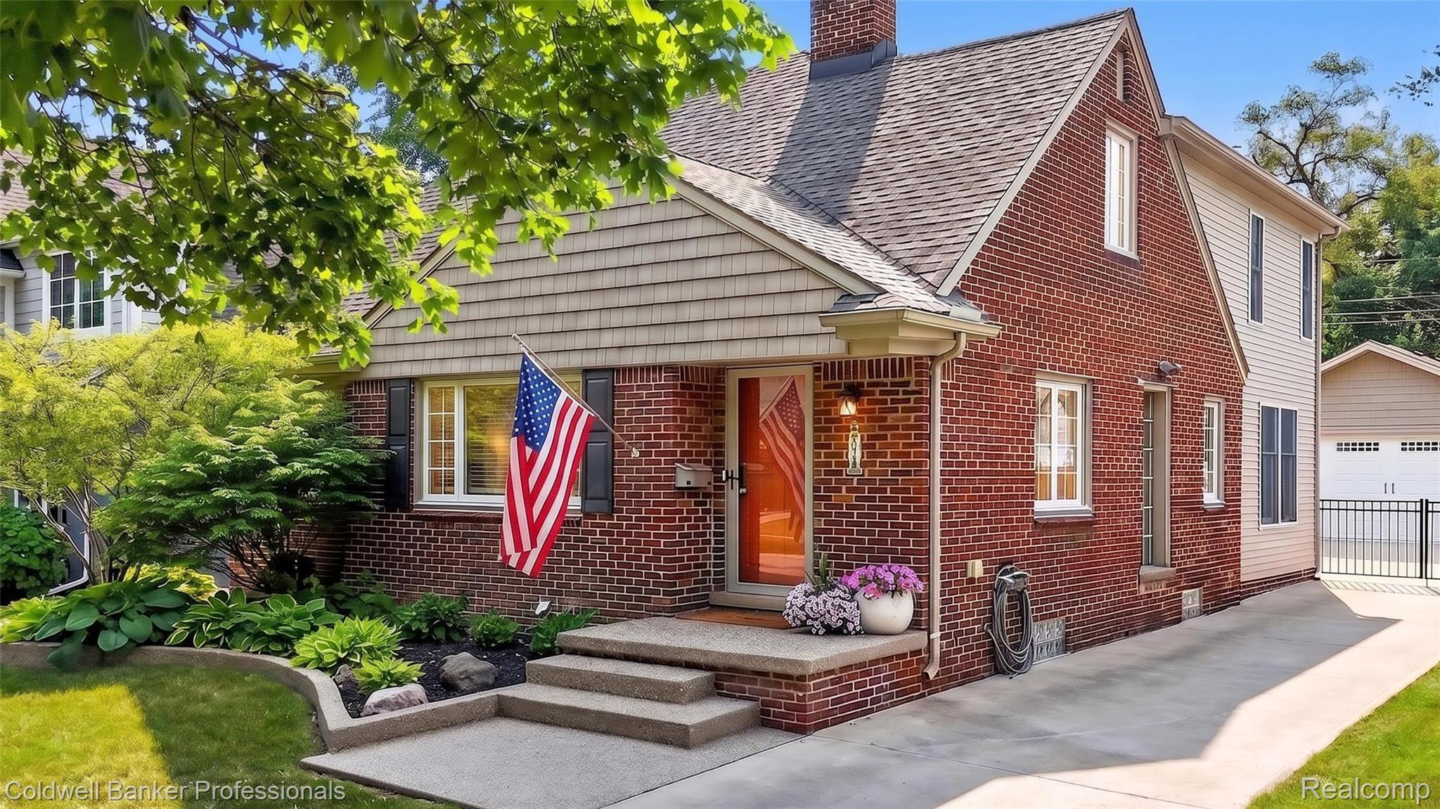 2666 Windemere Road Birmingham, MI 48009 - Photo 1 of 24 Brick and shingle exterior with a gabled roofline, concrete porch, and manicured landscaping