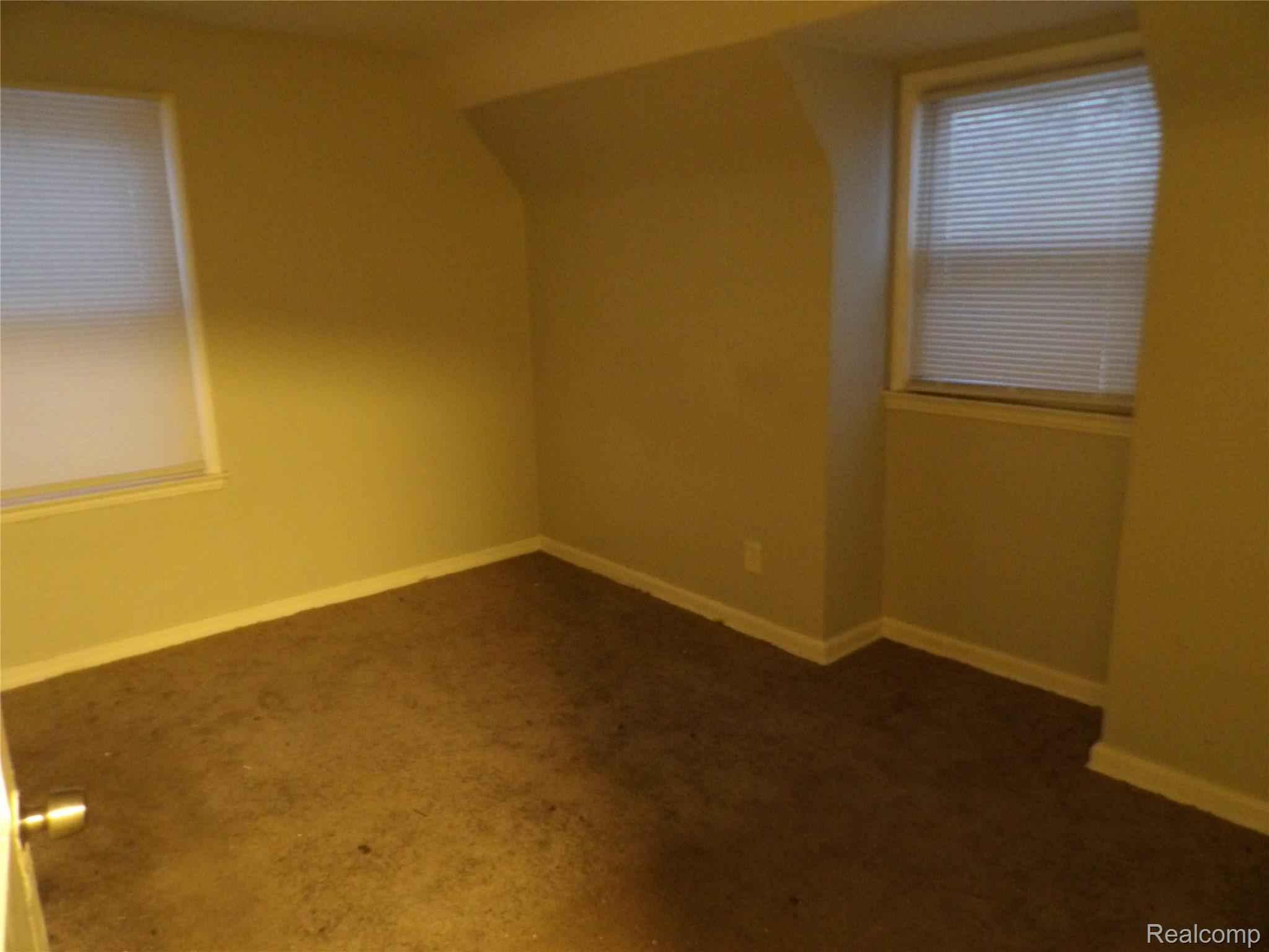 19985 Meyers Road Detroit, MI 48235 - Photo 13 of 16 Bonus room featuring dark carpet and lofted ceiling