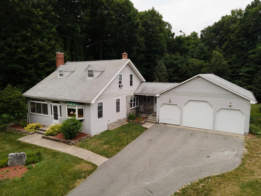 38 Berwick Road Longmeadow, MA 01106 - Photo 1 of 33 a view of a white house next to a yard and large trees
