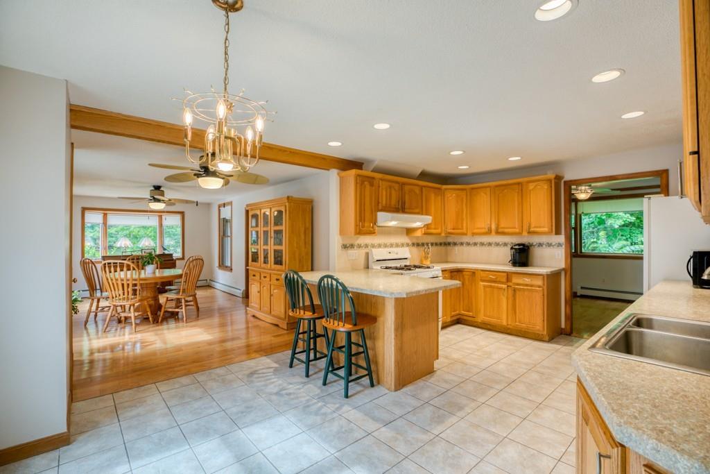 38 Berwick Road Longmeadow, MA 01106 - Photo 8 of 33 a view of a dining room with furniture a chandelier and kitchen view