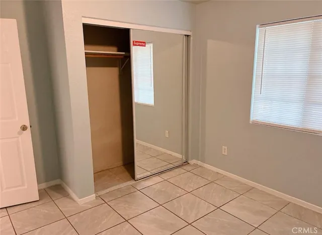 a view of a closet area with wooden floor