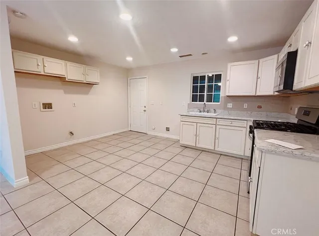 a kitchen with a sink cabinets and appliances