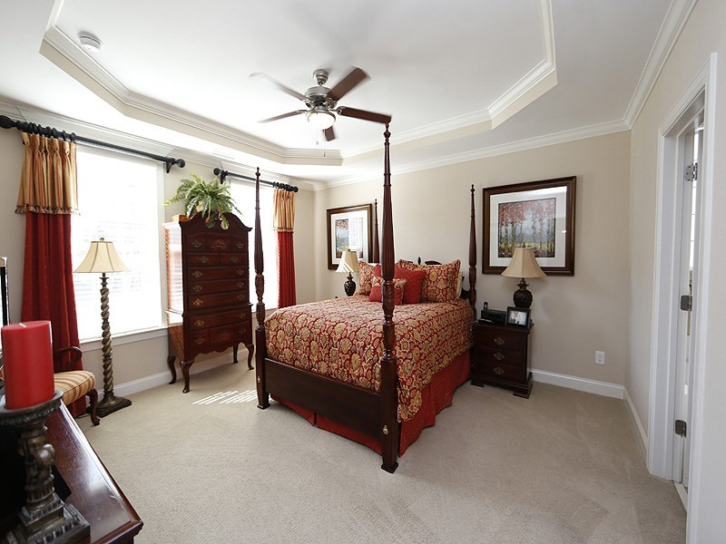 1145 Chapanoke Road Raleigh, NC 27603 - Photo 15 of 25 The first floor master suite with tray ceiling and fan, is nestled away in the front of the home. Master Bedroom