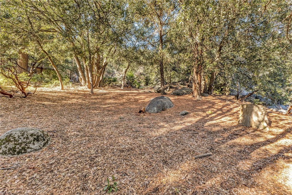0 Jeffery Pine Road Idyllwild, CA 92549 - Photo 8 of 8 a backyard of a house with large trees and outdoor seating