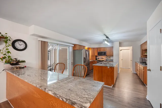 a kitchen with stainless steel appliances granite countertop sink stove top oven and cabinets