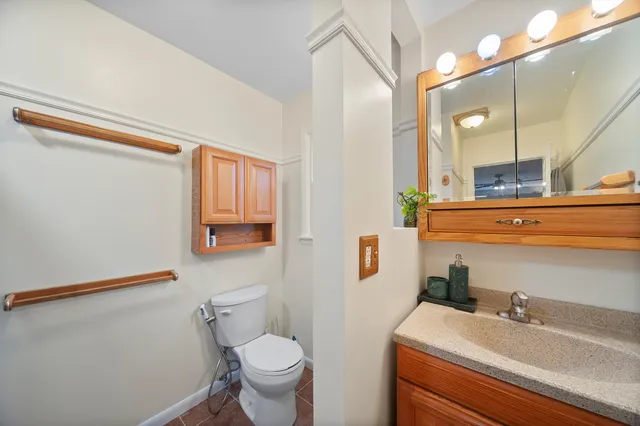 a bathroom with a sink a toilet and mirror