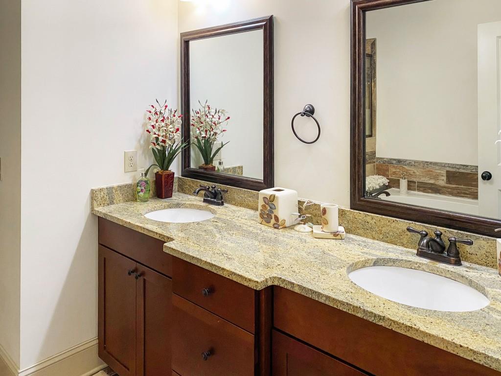 598 Ansley Circle Northeast Atlanta, GA 30324 - Photo 14 of 24 a bathroom with a granite countertop sink and a mirror