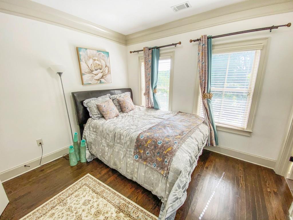 598 Ansley Circle Northeast Atlanta, GA 30324 - Photo 17 of 24 a bed sitting in a bedroom next to a window