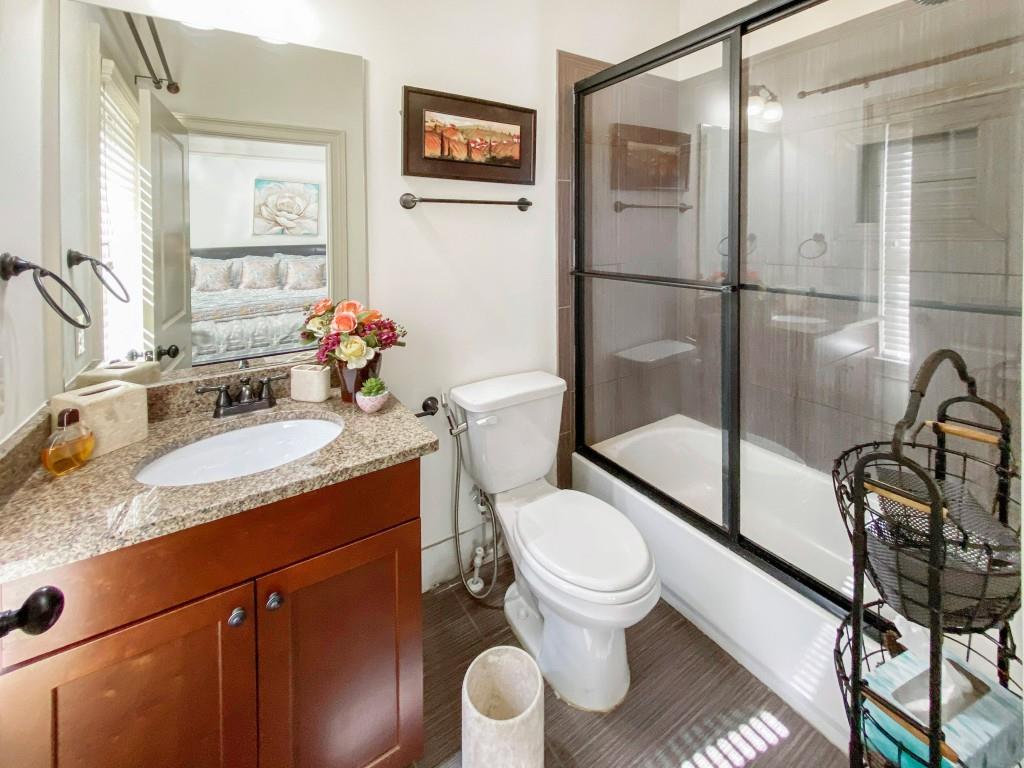 598 Ansley Circle Northeast Atlanta, GA 30324 - Photo 19 of 24 a bathroom with a granite countertop sink toilet and shower