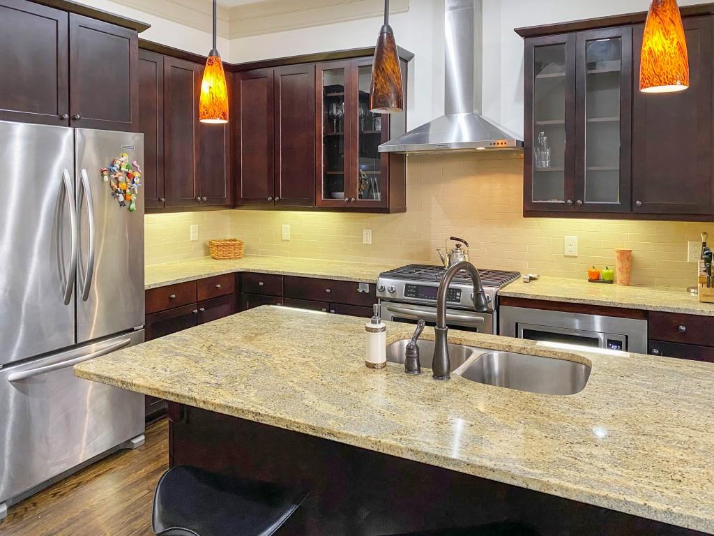 598 Ansley Circle Northeast Atlanta, GA 30324 - Photo 3 of 24 a kitchen with stainless steel appliances granite countertop a sink and a refrigerator