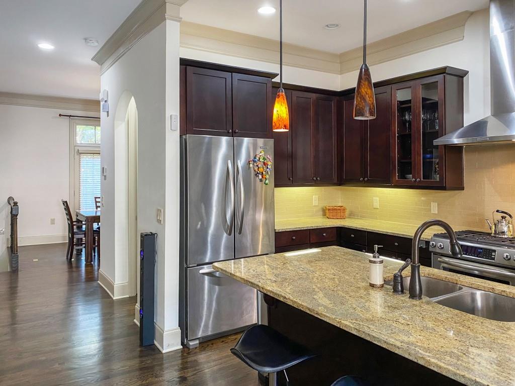 598 Ansley Circle Northeast Atlanta, GA 30324 - Photo 4 of 24 a kitchen with granite countertop a sink a refrigerator and wooden floor