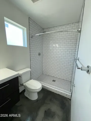 a bathroom with a toilet and a shower