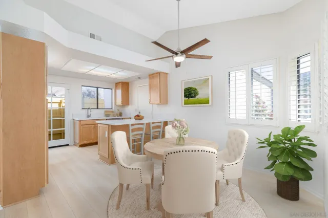 a living room with furniture a large window and a chandelier