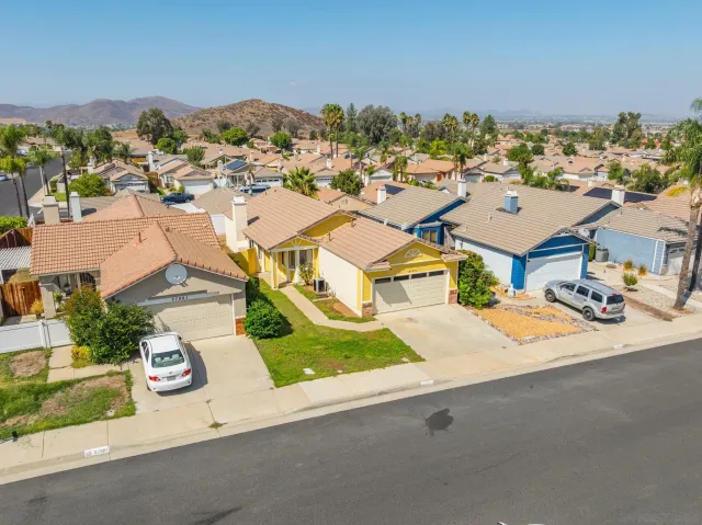 an aerial view of a residential building and an outdoor space