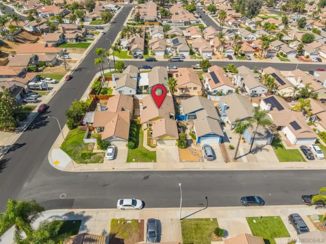 an aerial view of residential houses with outdoor space