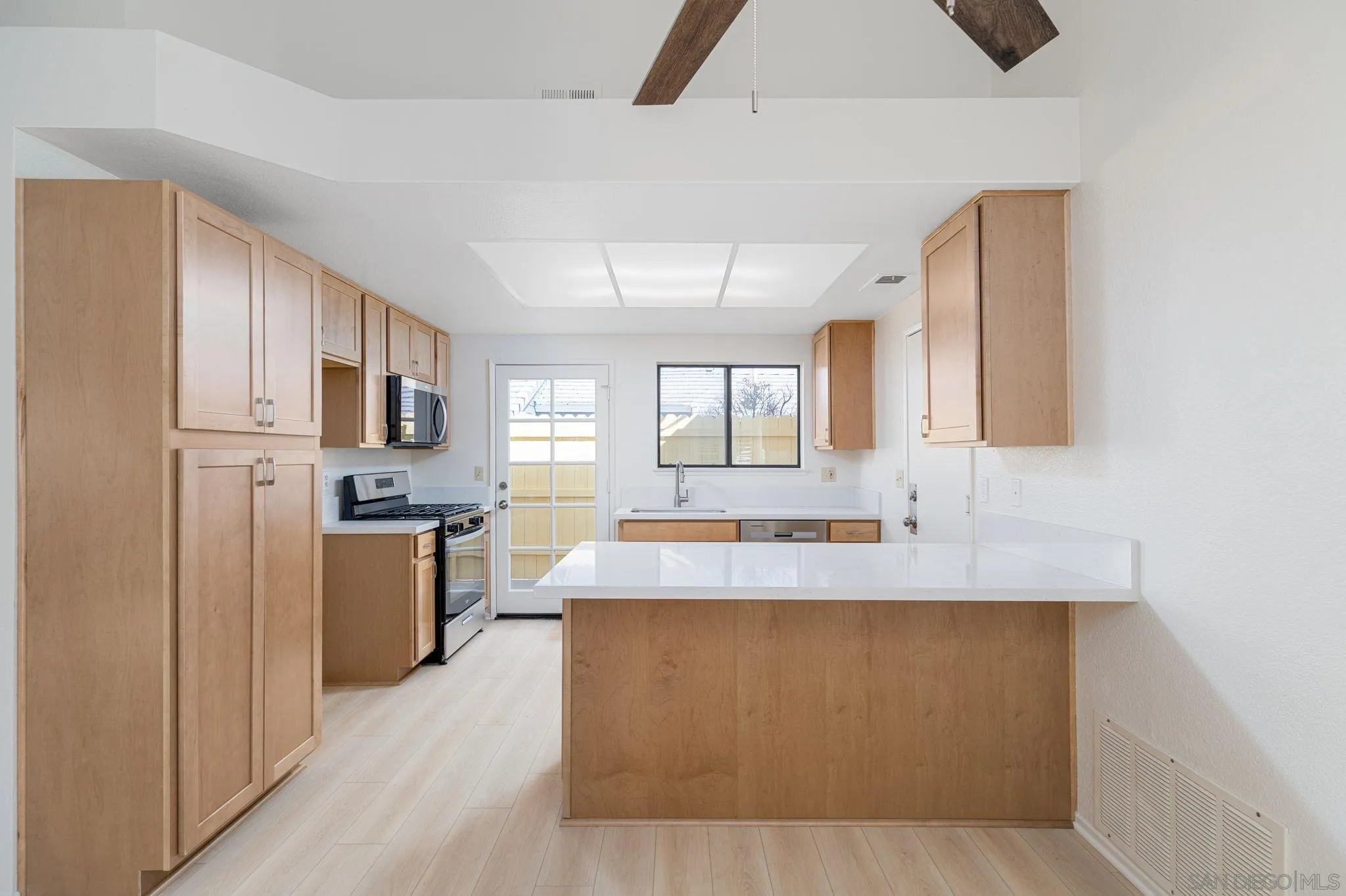 27971 Red Dawn Drive Menifee, CA 92585 - Photo 4 of 42 a living room with stainless steel appliances kitchen island granite countertop a refrigerator a stove top oven a sink and dishwasher