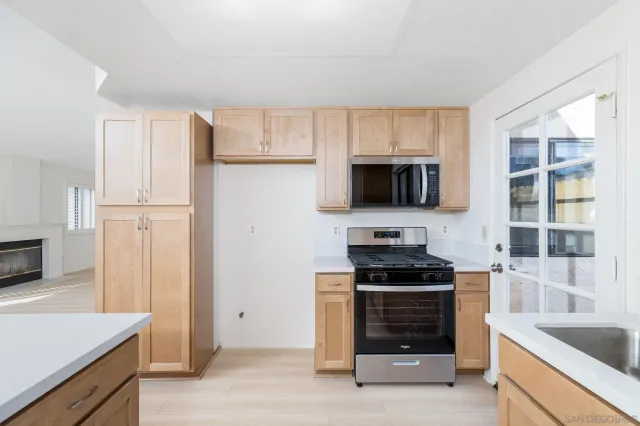 a kitchen with granite countertop a stove and a refrigerator
