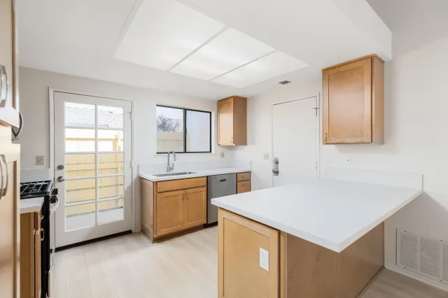 a kitchen with a stove a sink and a refrigerator