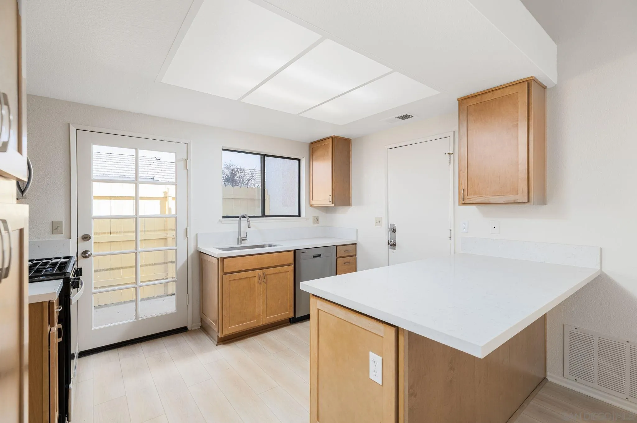 27971 Red Dawn Drive Menifee, CA 92585 - Photo 7 of 42 a kitchen with a stove a sink and a refrigerator