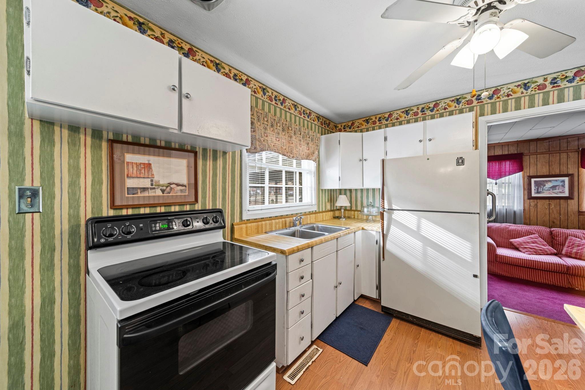 5 Cartwright Street York, SC 29745 - Photo 14 of 28 a kitchen with granite countertop a stove top oven cabinets and a refrigerator