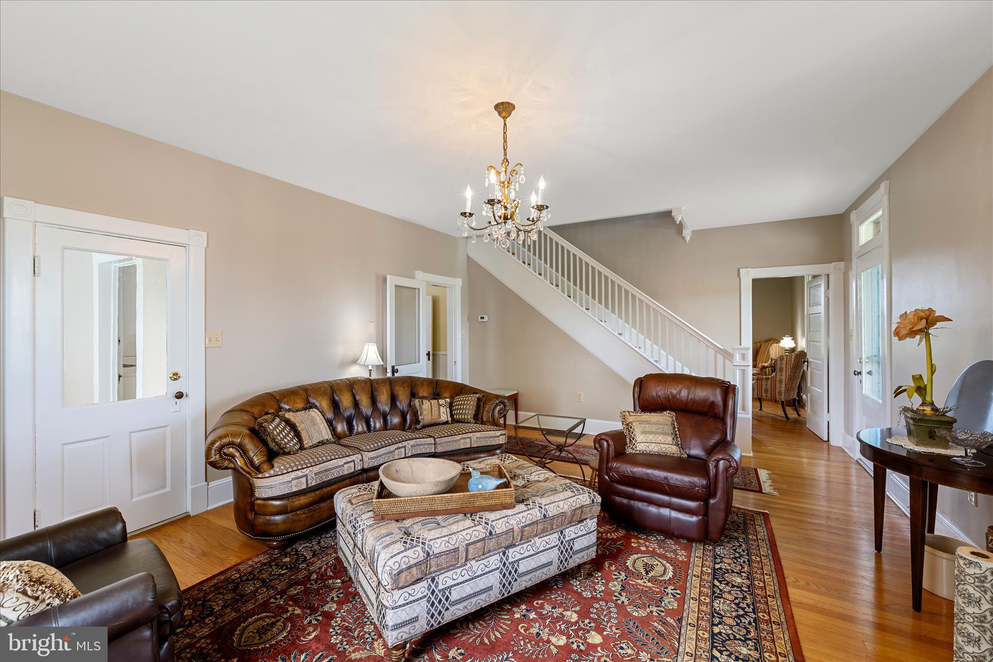 5452 Middle Road Winchester, VA 22602 - Photo 13 of 52 a living room with furniture a rug and a chandelier