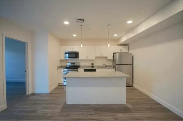 a kitchen with a sink stainless steel appliances and cabinets