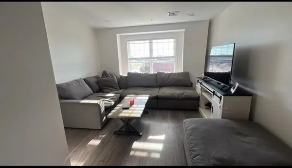 a bedroom with a bed and a night stand